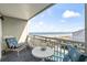 Relaxing balcony with ocean views, patio furniture, and a glimpse of the community pool at 1581 S Waccamaw Dr. # 303, Murrells Inlet, SC 29576