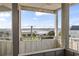 Balcony view overlooking a scenic waterway with lush greenery and clear skies at 1581 S Waccamaw Dr. # 303, Murrells Inlet, SC 29576