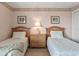 Charming bedroom with two twin beds, a nightstand, and coordinated decor at 1581 S Waccamaw Dr. # 303, Murrells Inlet, SC 29576