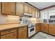 Charming kitchen featuring wooden cabinets and classic white appliances at 1581 S Waccamaw Dr. # 303, Murrells Inlet, SC 29576
