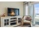 Cozy living room space with TV, entertainment center, and natural light perfect for relaxation at 1581 S Waccamaw Dr. # 303, Murrells Inlet, SC 29576