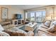 Relax in this cozy living room that features access to a private balcony with ocean views at 1581 S Waccamaw Dr. # 303, Murrells Inlet, SC 29576