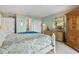 Bright main bedroom with a comfortable bed, dresser, and closet at 1581 S Waccamaw Dr. # 303, Murrells Inlet, SC 29576