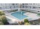 Community pool surrounded by lounge chairs and seating areas within the Waterforde condo complex at 1581 S Waccamaw Dr. # 303, Murrells Inlet, SC 29576