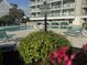 The community pool is surrounded by lush landscaping, providing a tranquil and inviting outdoor space at 1581 S Waccamaw Dr. # 303, Murrells Inlet, SC 29576