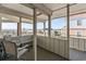 Enclosed porch with seating, offering serene views of the surrounding waterway and coastal landscape at 1581 S Waccamaw Dr. # 303, Murrells Inlet, SC 29576