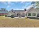 Large backyard featuring a patio with outdoor dining set at 1625 Deer Park Ln., Surfside Beach, SC 29575
