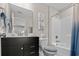 Well-lit bathroom featuring a vanity with storage, a toilet, and a shower/tub combo with a white shower curtain at 2105 Ballast Ct., Myrtle Beach, SC 29579