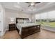 Tranquil bedroom with tray ceiling, large window, and elegant dark wood furniture at 2105 Ballast Ct., Myrtle Beach, SC 29579