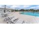 Community pool area featuring ample seating, lounge chairs, and a nearby building at 2105 Ballast Ct., Myrtle Beach, SC 29579