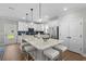 Bright kitchen with white cabinets, quartz countertops, and a center island with seating at 2105 Ballast Ct., Myrtle Beach, SC 29579