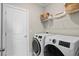 Bright laundry room features modern washer and dryer and wire shelving for organized storage at 2105 Ballast Ct., Myrtle Beach, SC 29579