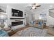 Cozy living room featuring a fireplace, a ceiling fan, and comfortable leather seating at 2105 Ballast Ct., Myrtle Beach, SC 29579