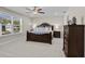 Elegant main bedroom featuring a large window, dark wood furniture, and cozy decor for comfort and style at 2105 Ballast Ct., Myrtle Beach, SC 29579