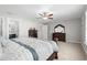 Spacious main bedroom with a dark wood dresser, ceiling fan, and doorway to the ensuite bathroom at 2105 Ballast Ct., Myrtle Beach, SC 29579
