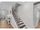 Elegant staircase with wood treads, detailed iron railing, and white trim, creating a welcoming entrance at 2105 Ballast Ct., Myrtle Beach, SC 29579