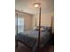 Bedroom featuring a four-poster bed with blue bedding, complemented by natural light from the window at 320 Mckaylas Ct., Myrtle Beach, SC 29579