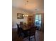 Traditional dining room featuring a wooden table set with flowers, complemented by a chandelier and natural light at 320 Mckaylas Ct., Myrtle Beach, SC 29579