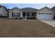 Inviting one-story home featuring manicured lawn, attached garage, and a charming front porch at 320 Mckaylas Ct., Myrtle Beach, SC 29579