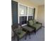 Cozy front porch sitting area with charming wicker furniture and green cushions at 320 Mckaylas Ct., Myrtle Beach, SC 29579