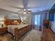 Spacious bedroom with hardwood furnishings, a ceiling fan, and ample natural light at 400 Melrose Pl. # 14-A, Myrtle Beach, SC 29572