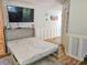 Comfortable bedroom with Murphy bed, neutral decor, and wall-mounted TV at 400 Melrose Pl. # 14-A, Myrtle Beach, SC 29572