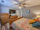Comfortable bedroom with wooden furnishings, a ceiling fan, and modern decor at 400 Melrose Pl. # 14-A, Myrtle Beach, SC 29572