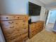 Bedroom featuring wood dressers, a TV, and neutral wall paint at 400 Melrose Pl. # 14-A, Myrtle Beach, SC 29572