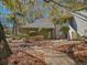 Charming exterior view of a multi-level home with mature trees and a stone walkway at 400 Melrose Pl. # 14-A, Myrtle Beach, SC 29572