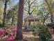 Picturesque gazebo surrounded by lush greenery and colorful azaleas, creating a serene outdoor space at 400 Melrose Pl. # 14-A, Myrtle Beach, SC 29572