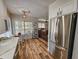Open concept kitchen with stainless steel refrigerator and connection to living room area at 400 Melrose Pl. # 14-A, Myrtle Beach, SC 29572