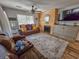 Living room showcasing comfortable seating, a fireplace with wood paneling, and natural light at 400 Melrose Pl. # 14-A, Myrtle Beach, SC 29572