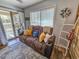 A cozy living room featuring comfortable seating, sliding glass door access to a porch, and a window at 400 Melrose Pl. # 14-A, Myrtle Beach, SC 29572