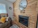 Charming living room with fireplace, wood accent wall, and decorative ladder at 400 Melrose Pl. # 14-A, Myrtle Beach, SC 29572