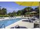 Refreshing community pool area with lounge chairs and umbrellas perfect for relaxation and leisure at 400 Melrose Pl. # 14-A, Myrtle Beach, SC 29572