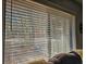 Cozy window view through blinds showcasing a green outdoor scene with trees and greenery at 400 Melrose Pl. # 14-A, Myrtle Beach, SC 29572