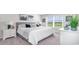 Comfortable bedroom featuring a large window, plush carpet, and neutral decor at 598 Strawberry Field Way, Galivants Ferry, SC 29544