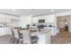 Open-concept kitchen with island, breakfast bar, and stainless steel microwave at 598 Strawberry Field Way, Galivants Ferry, SC 29544
