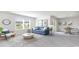 Bright living room with large windows, stylish decor, and dining area at 598 Strawberry Field Way, Galivants Ferry, SC 29544