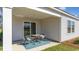 Cozy covered patio area with outdoor seating and sliding glass door access to the home at 598 Strawberry Field Way, Galivants Ferry, SC 29544