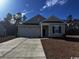 Charming single-Gathering home featuring a two-car garage and landscaped front yard at 623 Castillo Dr., Loris, SC 29569