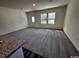 Open living area with plush carpeting and bright natural light from the windows at 623 Castillo Dr., Loris, SC 29569