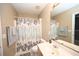 Cozy bathroom featuring a shower-tub combination and floral curtain at 100 Barnacle Ln. # S-4, Little River, SC 29566
