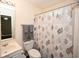 This bathroom features a vanity, toilet and shower behind a decorative shower curtain at 100 Barnacle Ln. # S-4, Little River, SC 29566
