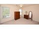 A bedroom has carpeted floors and includes dressers, a mirror, a ceiling fan, and a window at 100 Barnacle Ln. # S-4, Little River, SC 29566