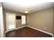 A bedroom offers wood floors, a ceiling fan, a television and access to the outdoor patio at 100 Barnacle Ln. # S-4, Little River, SC 29566