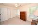 A bedroom has carpeted floors, a ceiling fan and includes a dresser with closets and a window at 100 Barnacle Ln. # S-4, Little River, SC 29566