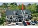 Exterior view of townhomes with black shutters, dormer windows, and parking; lush trees in the background at 100 Barnacle Ln. # S-4, Little River, SC 29566