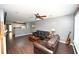Comfortable living room with dark wood floors, gray walls, ceiling fan, and an adjacent kitchen at 100 Barnacle Ln. # S-4, Little River, SC 29566