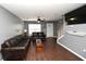 Open living area features hardwood floors, gray walls, ceiling fan, and staircase to the upper floor at 100 Barnacle Ln. # S-4, Little River, SC 29566
